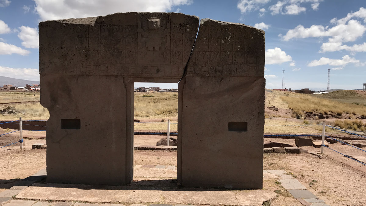 The Gateway of the Sun at Tiwanaku, Bolivia—a massive stone portal carved with intricate symbols and figures, believed to have held spiritual or astronomical significance for the ancient Tiwanaku people.